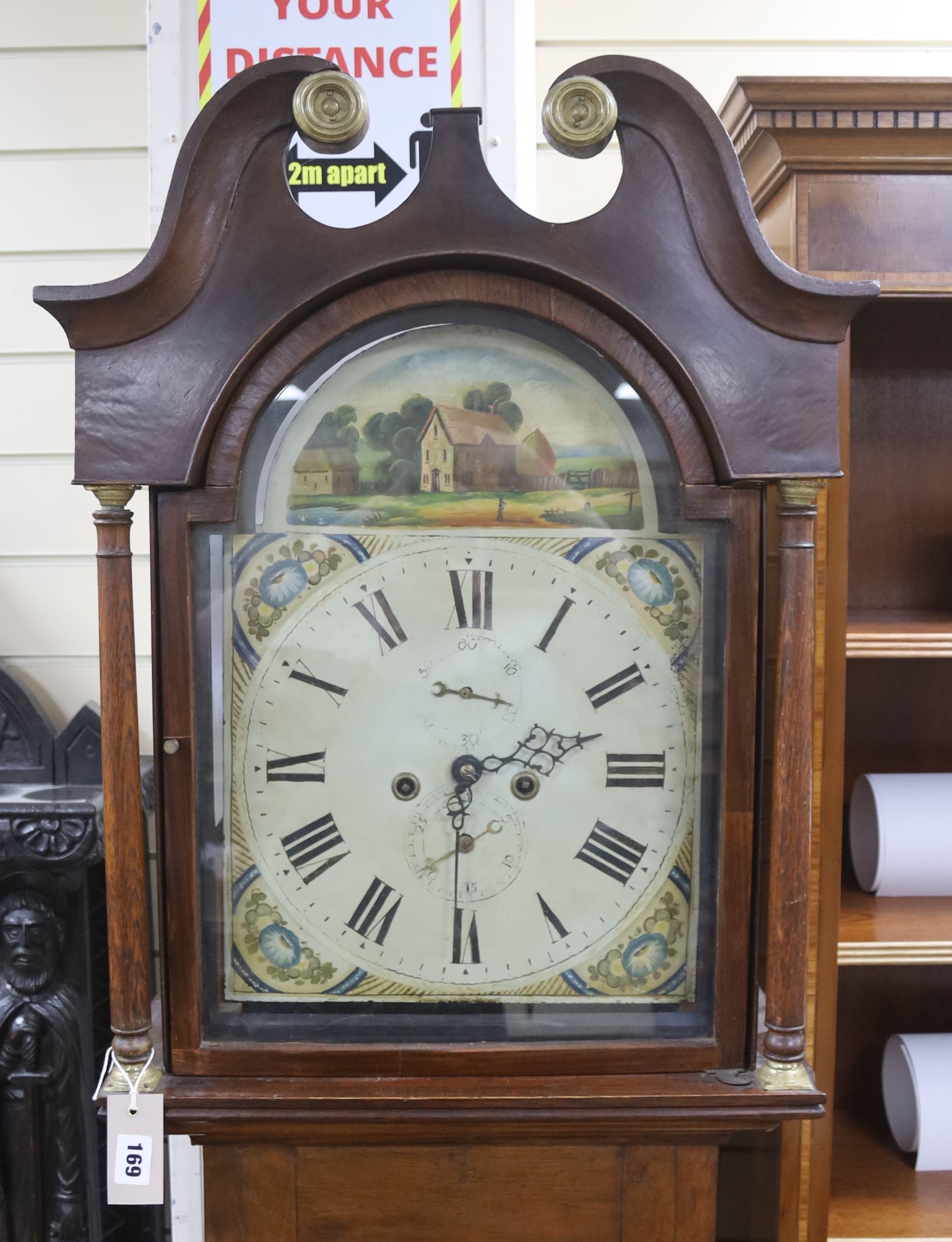 An early 19th century 8-day oak longcase clock, painted dial, with key, pendulum and weights, height 207cm